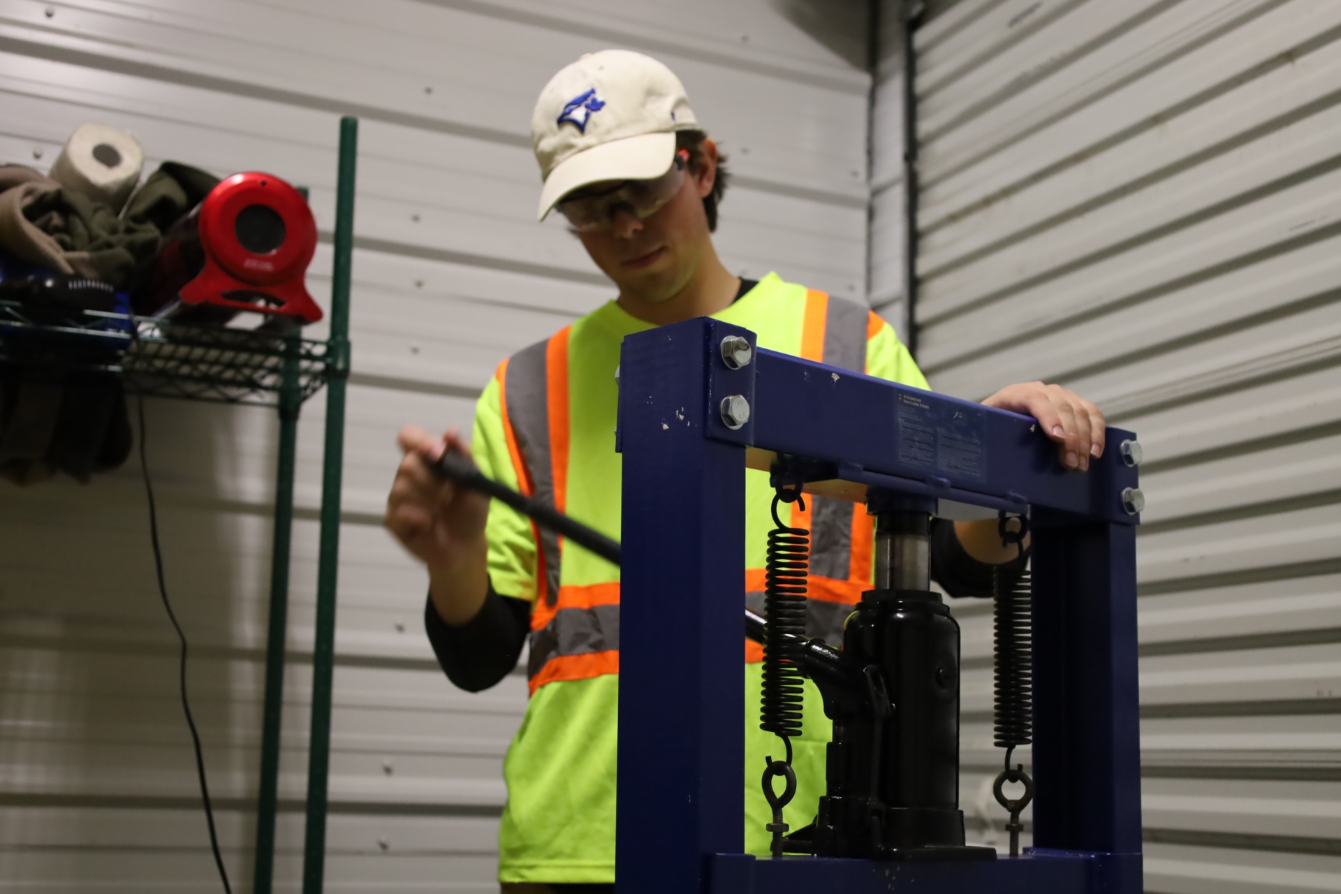 A Paper Trail team member operating the fire-brick press
