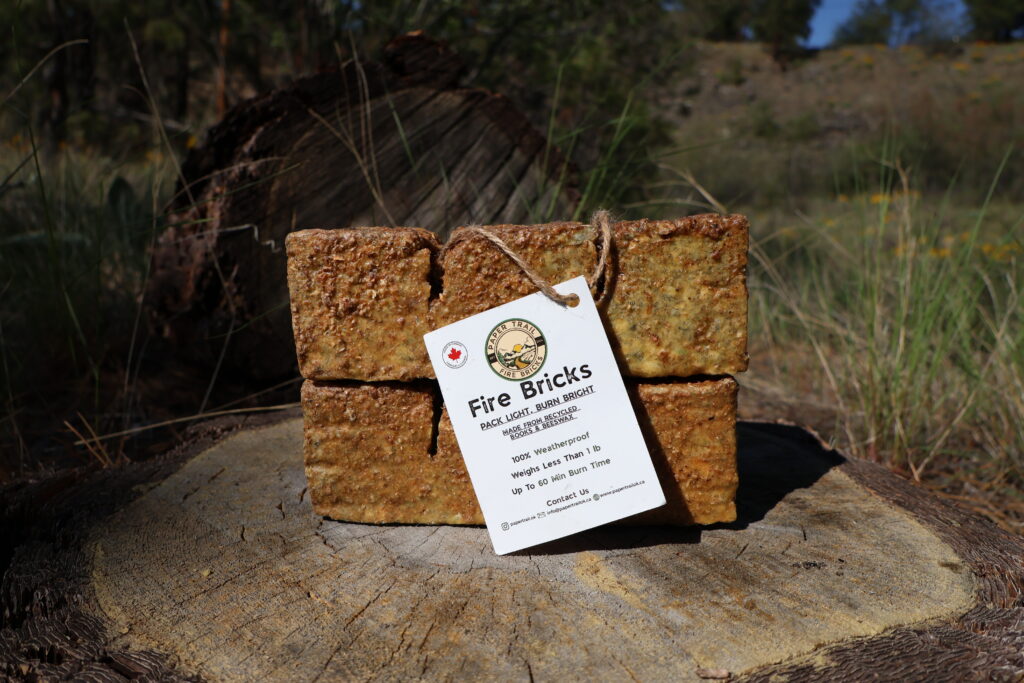 Two Paper Trail Fire Bricks bundled together on a tree stump