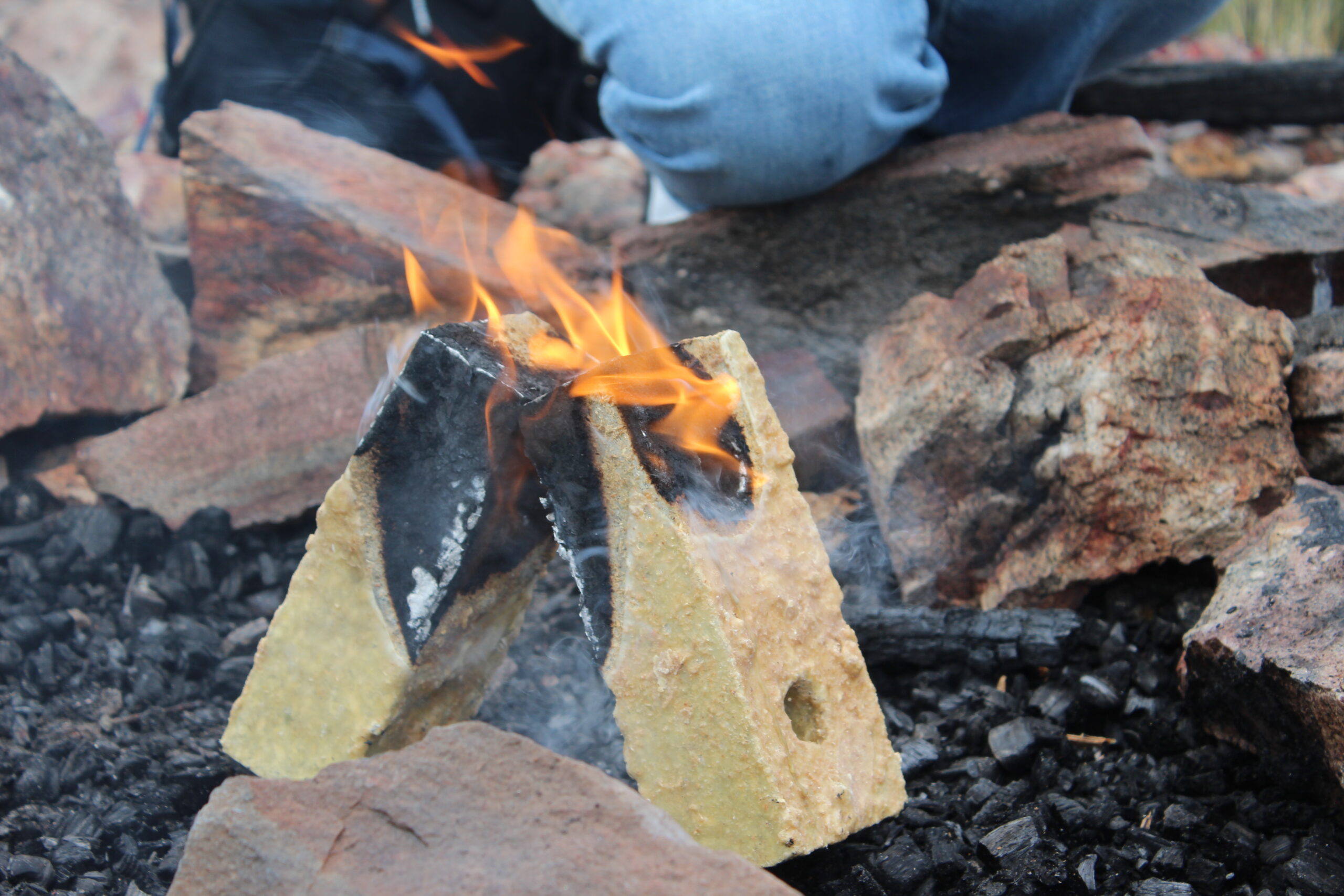 Original Paper Trail Fire Bricks burning in an outdoor stone fire ring