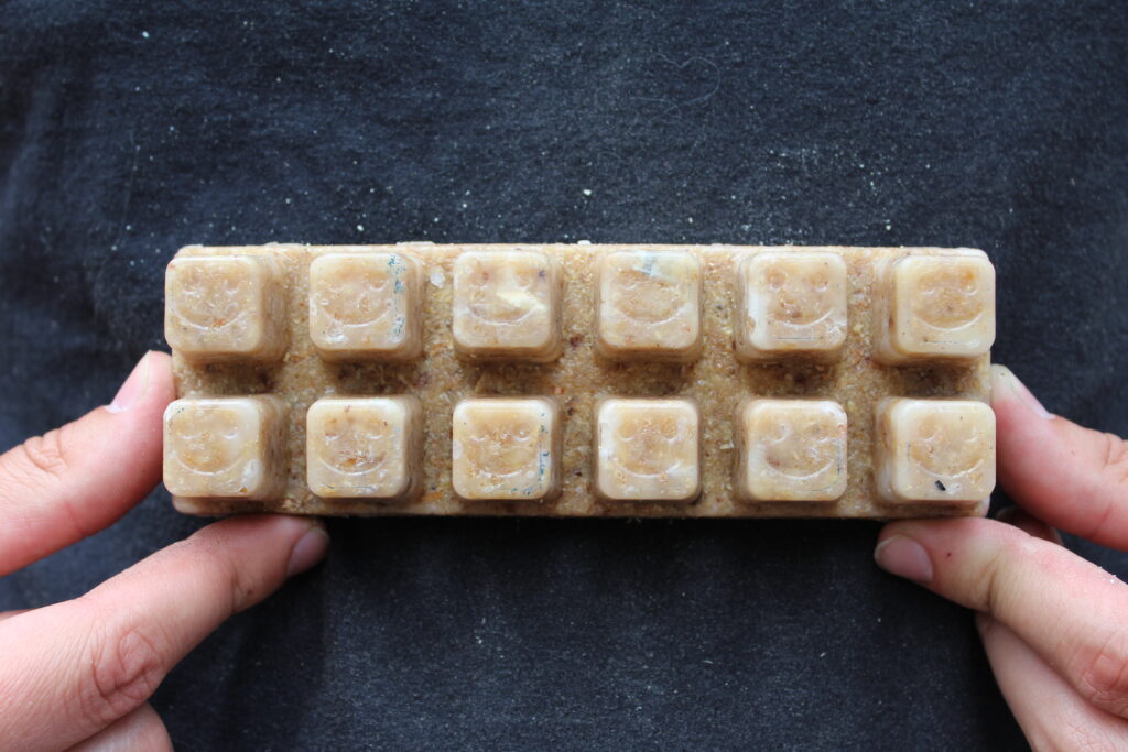 Hands holding a compact bar of twelve Smile Starters